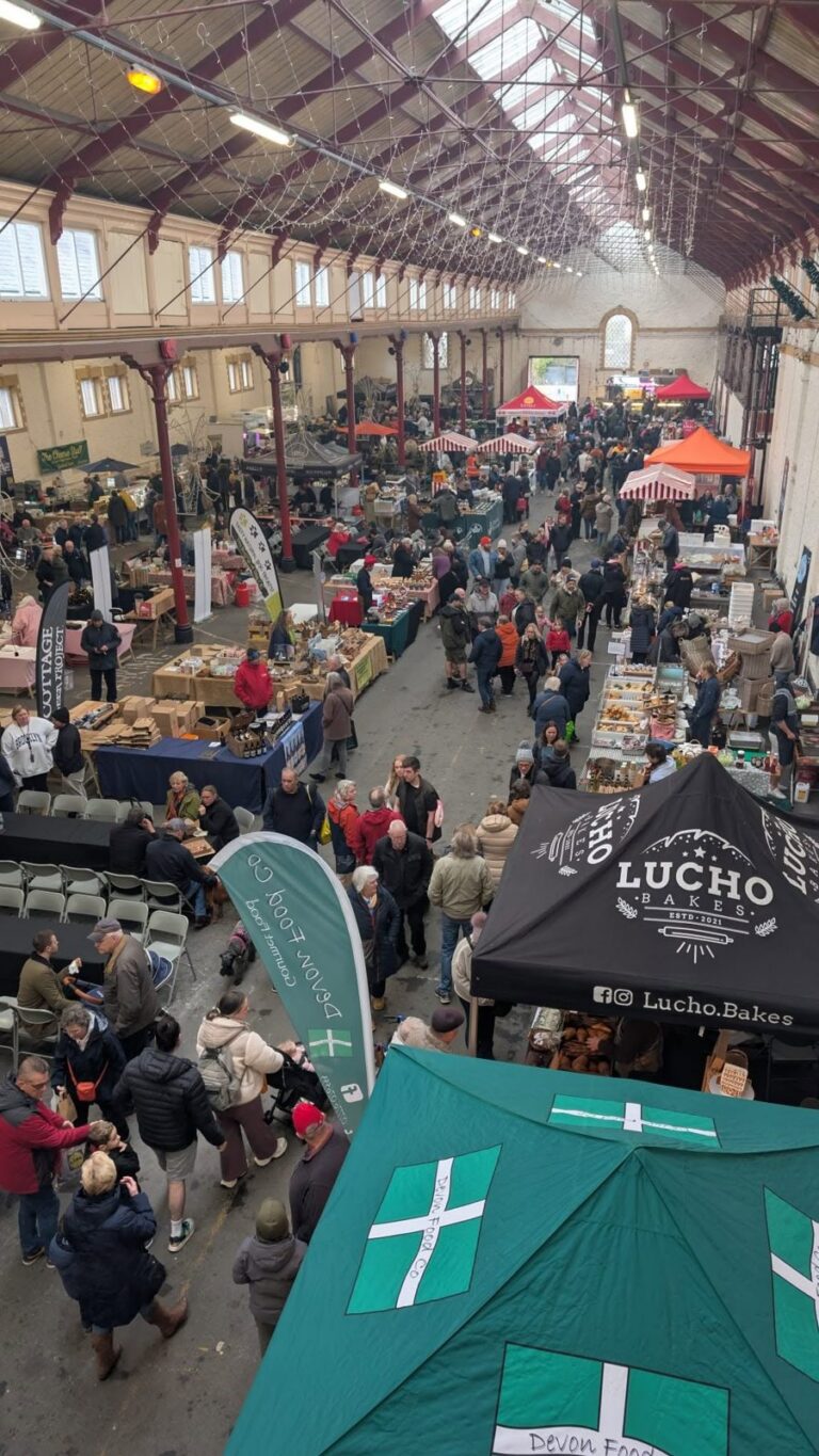 An elevated view of visitors and stalls filling the market hall at the food festival